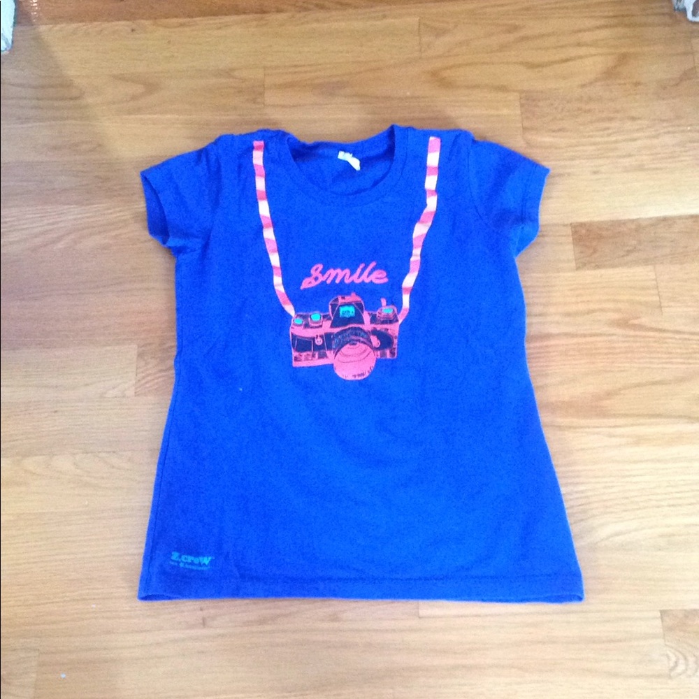 A blue shirt with picture of a camera on it